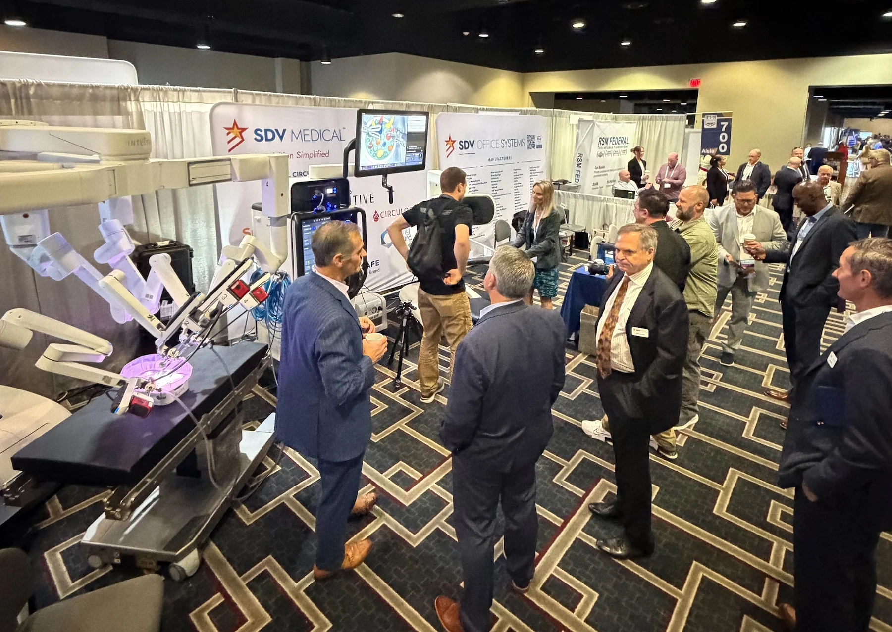 SDV Medical & SDV Office Systems Connecting with Partners at NVSBC VETS26 Attendees gather around the SDV Medical and SDV Office Systems exhibit booth at the NVSBC VETS26 Conference in New Orleans, exploring healthcare technology solutions and networking with industry partners focused on supporting veterans.