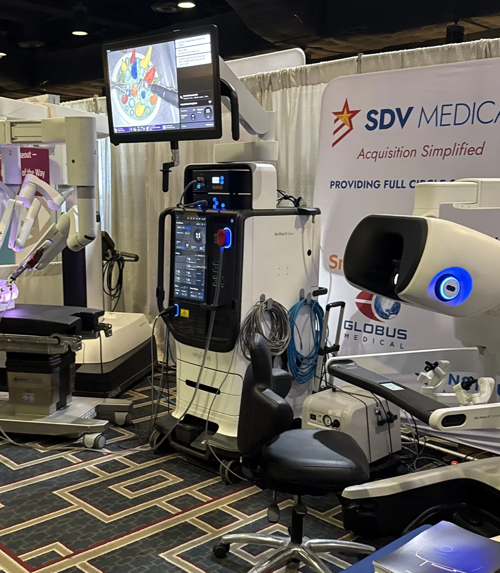 SDV Office Systems Showcases Advanced Surgical and Healthcare Technology at Industry Conference SDV Office Systems and SDV Medical exhibit booth featuring a robotic surgical system, surgeon console, and healthcare technology solutions displayed at a professional conference trade show.