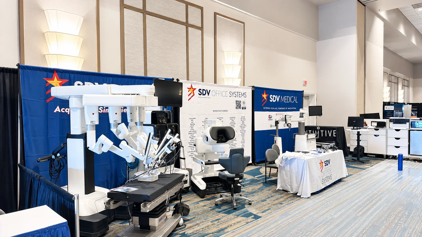 SDV Office Systems Showcases Advanced Surgical and Healthcare Technology at Industry Conference SDV Office Systems and SDV Medical exhibit booth featuring a robotic surgical system, surgeon console, and healthcare technology solutions displayed at a professional conference trade show.